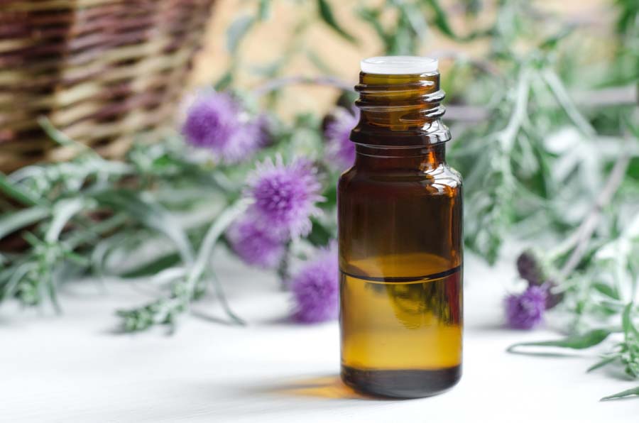 essential oil bottle with basket and thistle