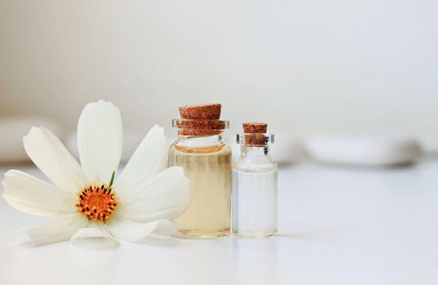 essential oil bottles with white flower